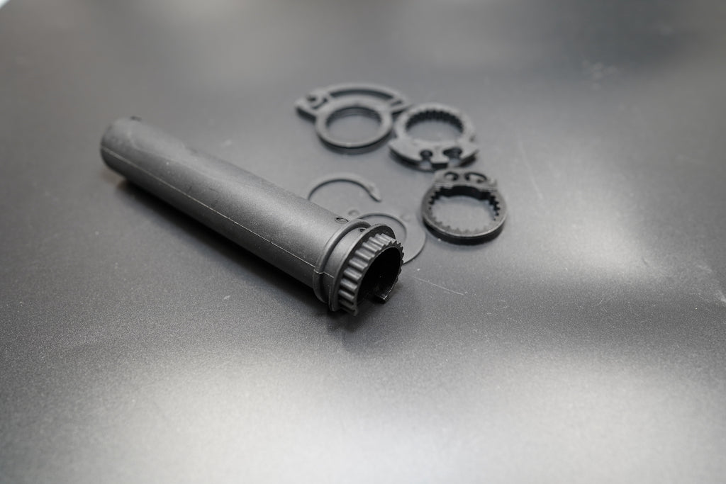 Angled side view showing throttle grip handle and internal gear mechanism.