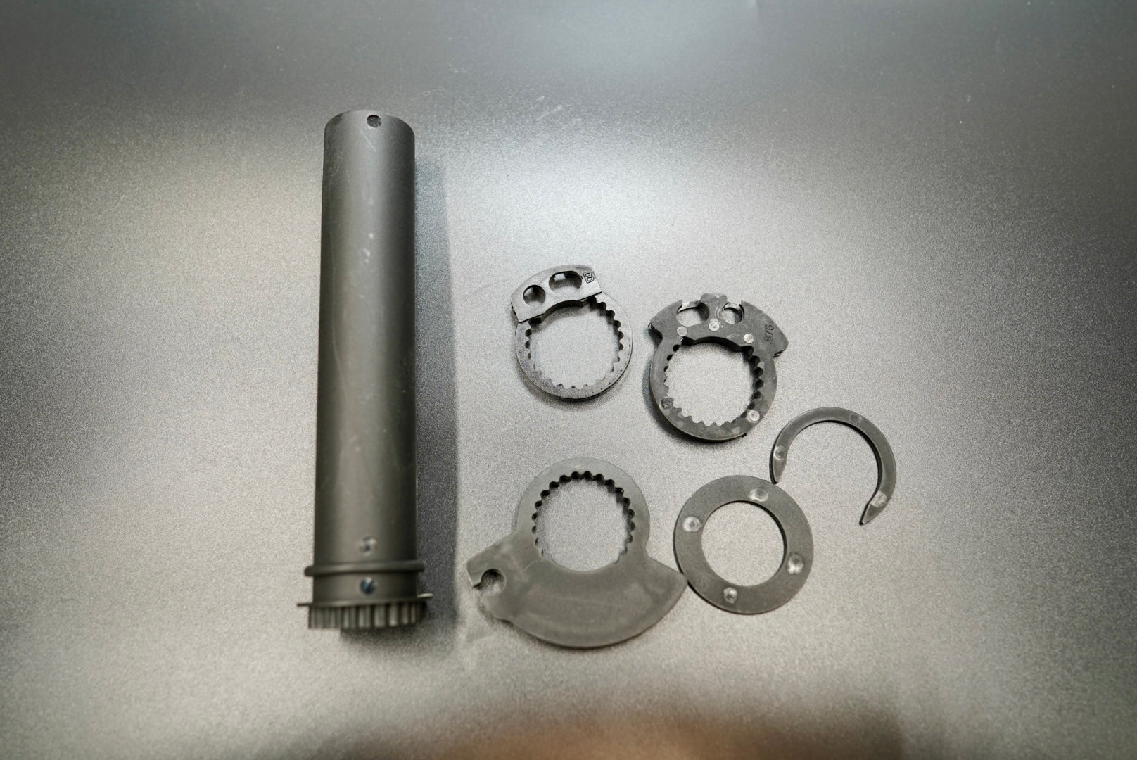 Universal motorcycle throttle twist grip tube with multiple gear rings, displayed flat on grey background