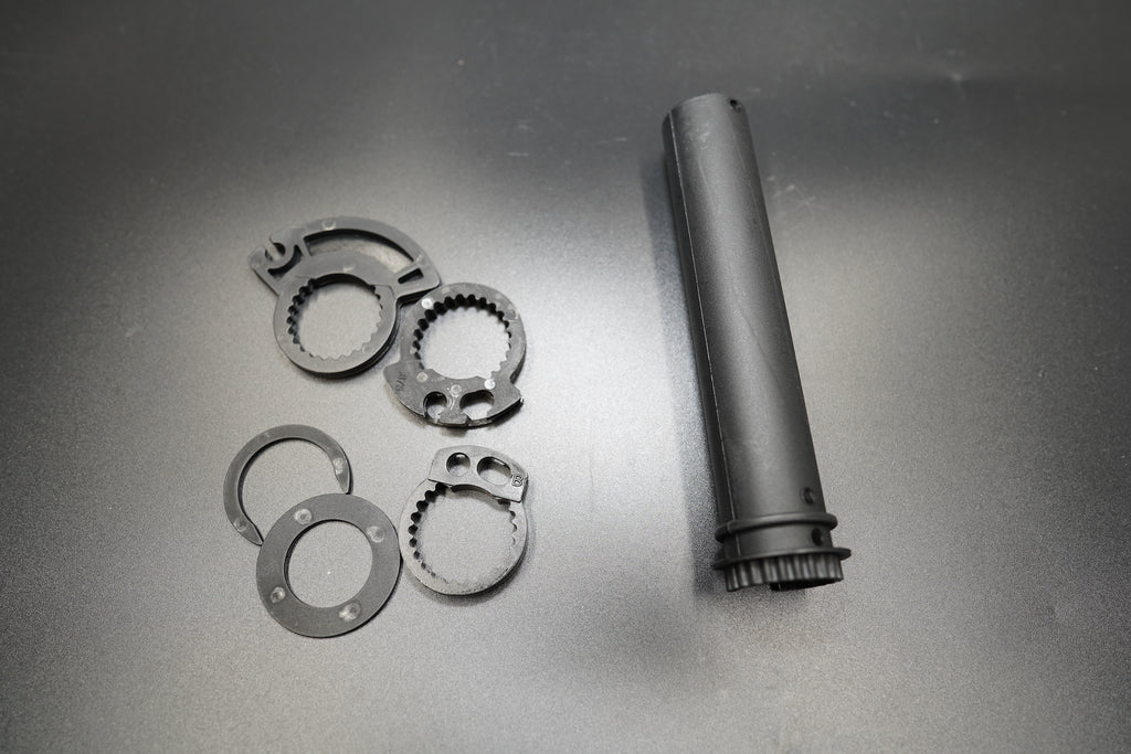 Set of throttle grip tube and adapter rings in 22mm and 25.4mm sizes, laid out for display.
