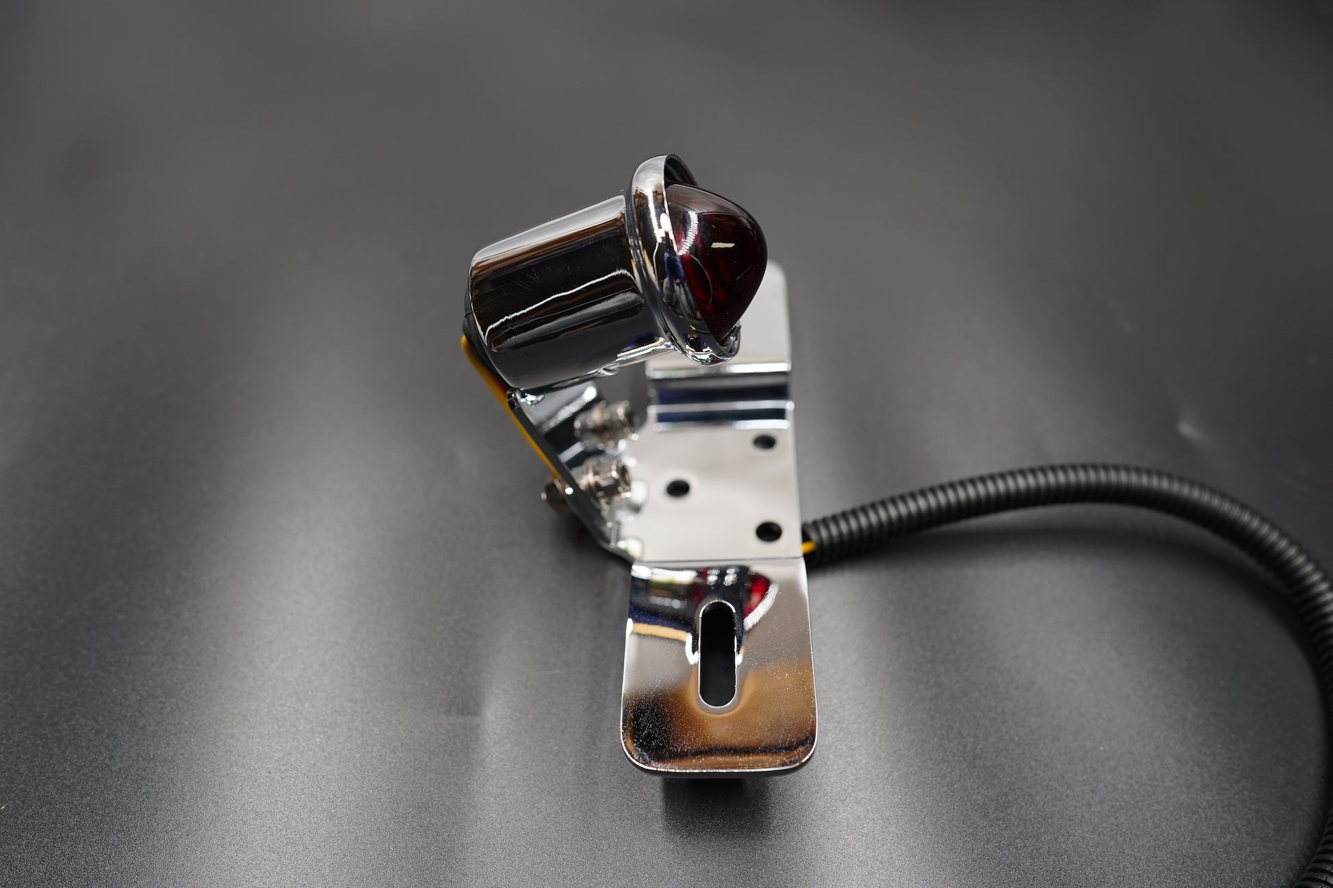 Flat lay view of the light and bracket on grey matte surface