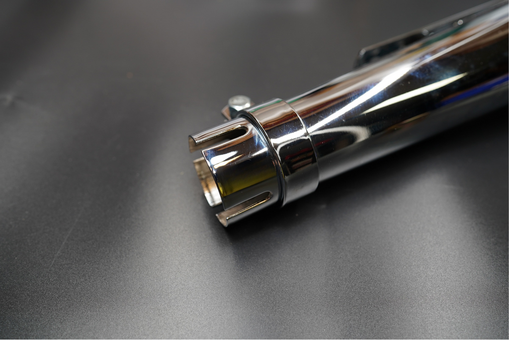 Rear outlet close-up focusing on circular baffle and exhaust tip.