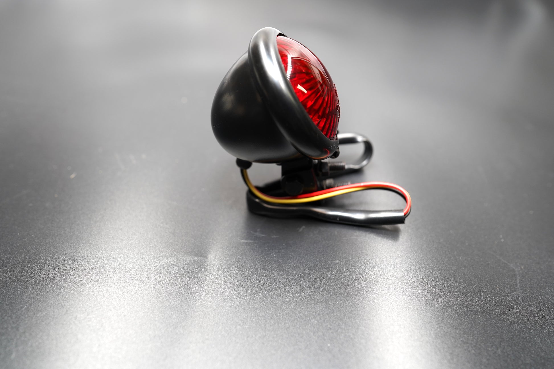 Rear view of tail light showing wiring and bracket mount — designed for universal 12V systems.