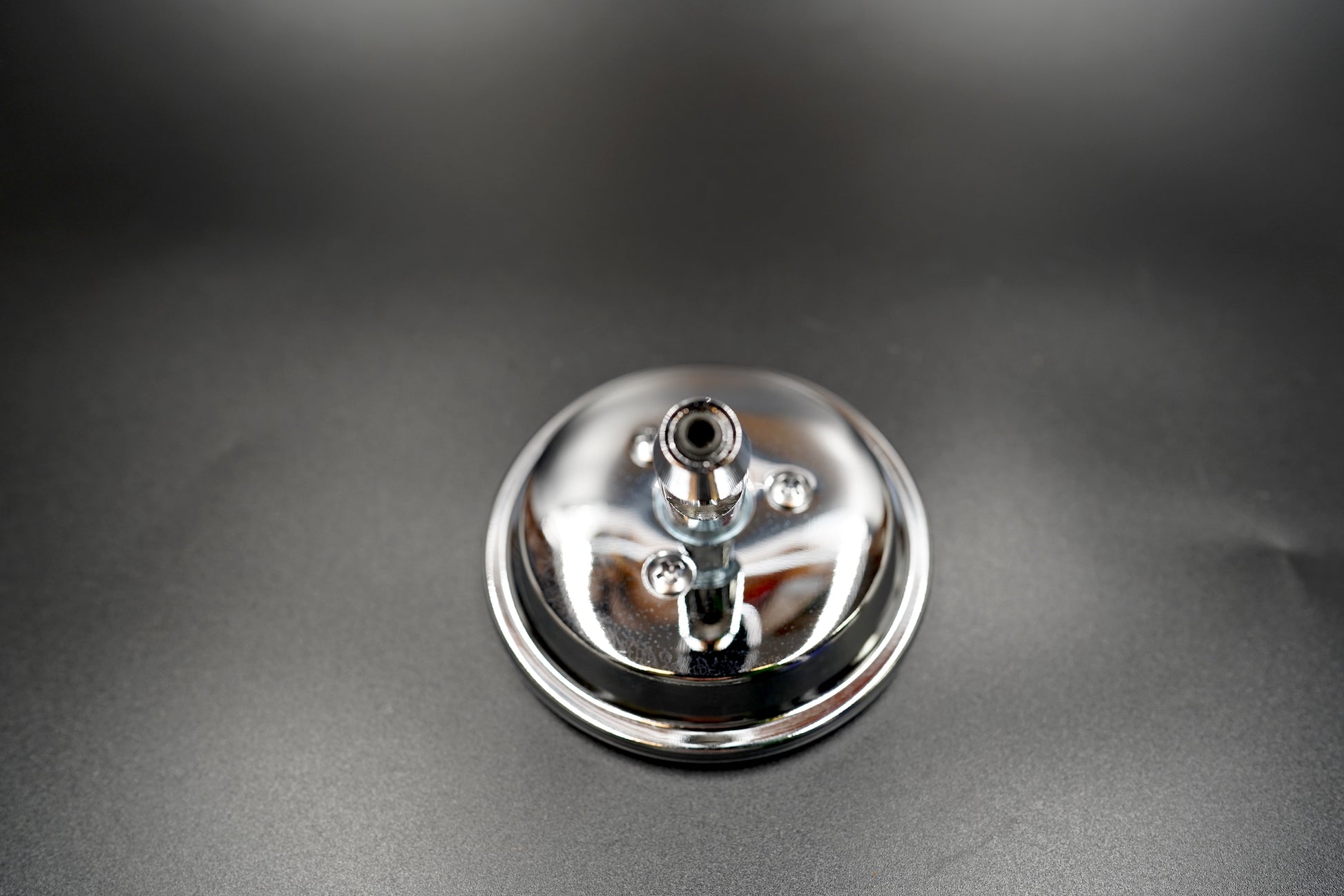 Front close-up of mirror face — polished chrome surface with classic round geometry.
