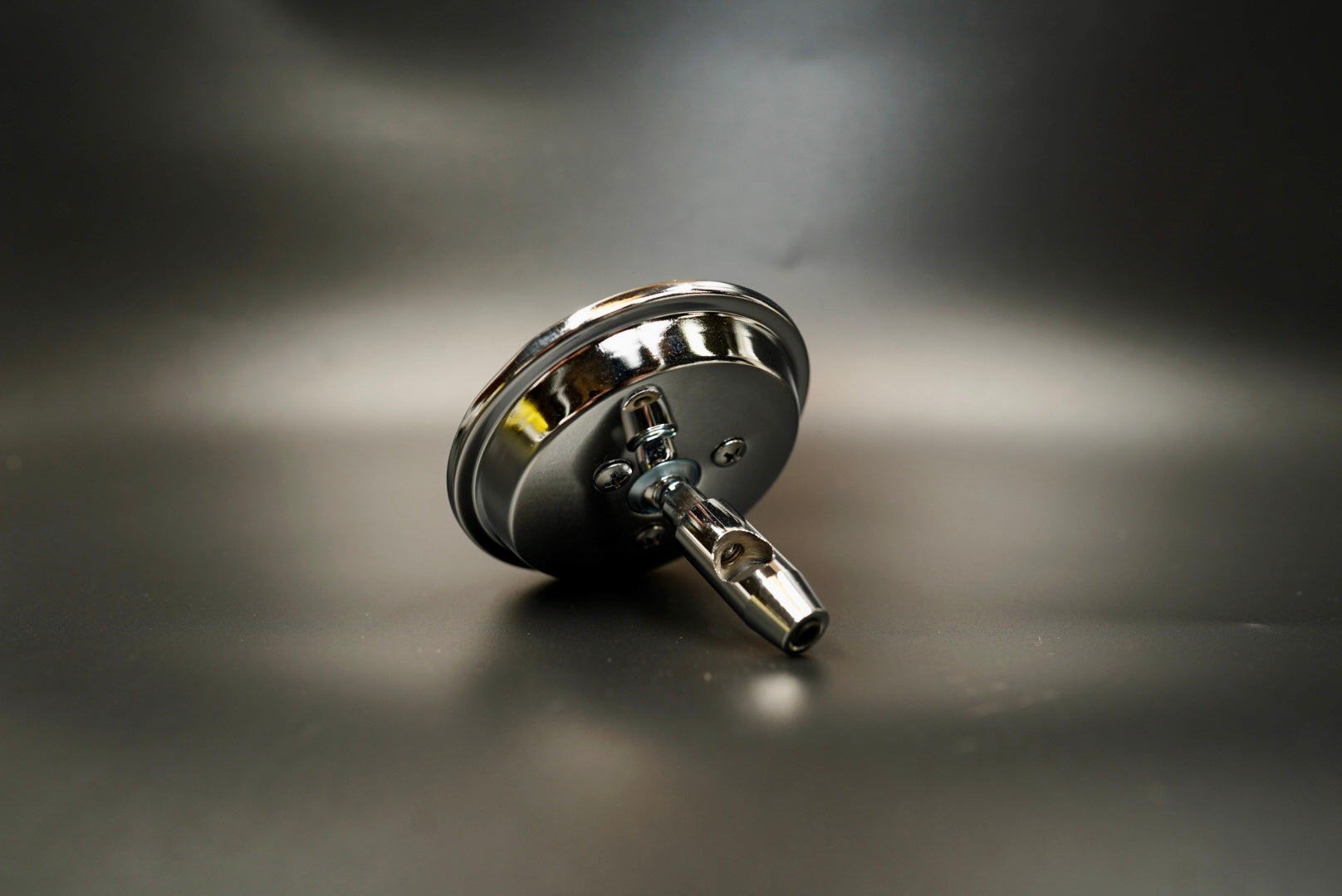 Front angled view of vintage round chrome motorcycle mirror — 4-inch minimalist design with clean reflection.