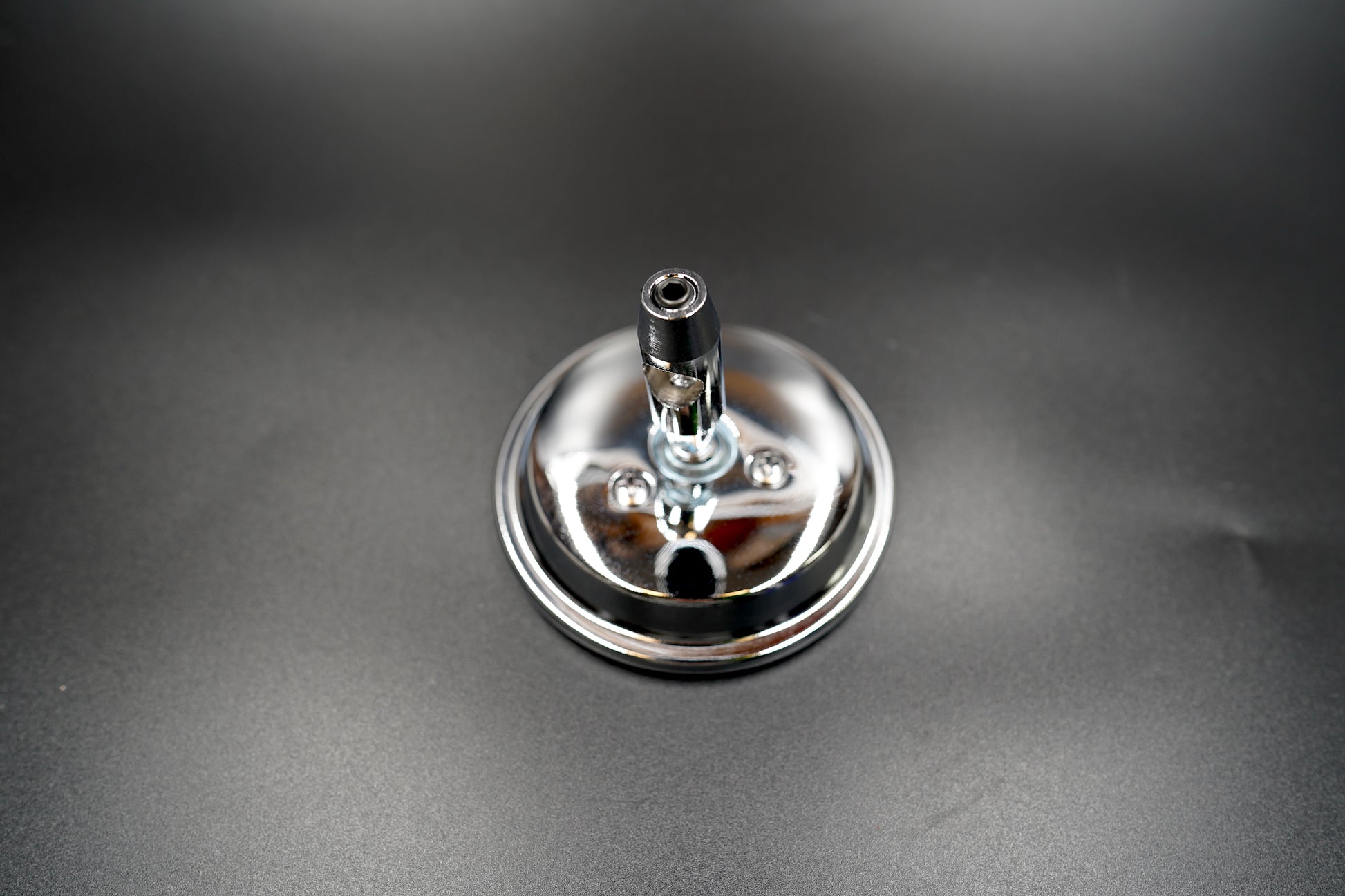 Top view of chrome mirror highlighting reflective finish and universal mounting joint.