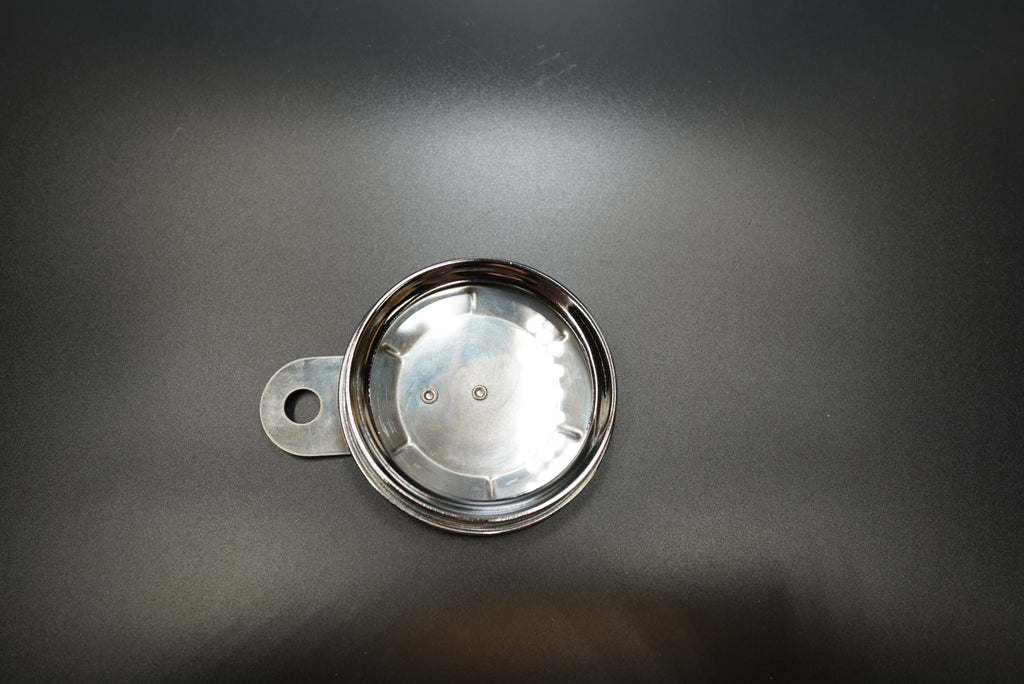 Angled view of classic round number plate highlighting smooth curved edge