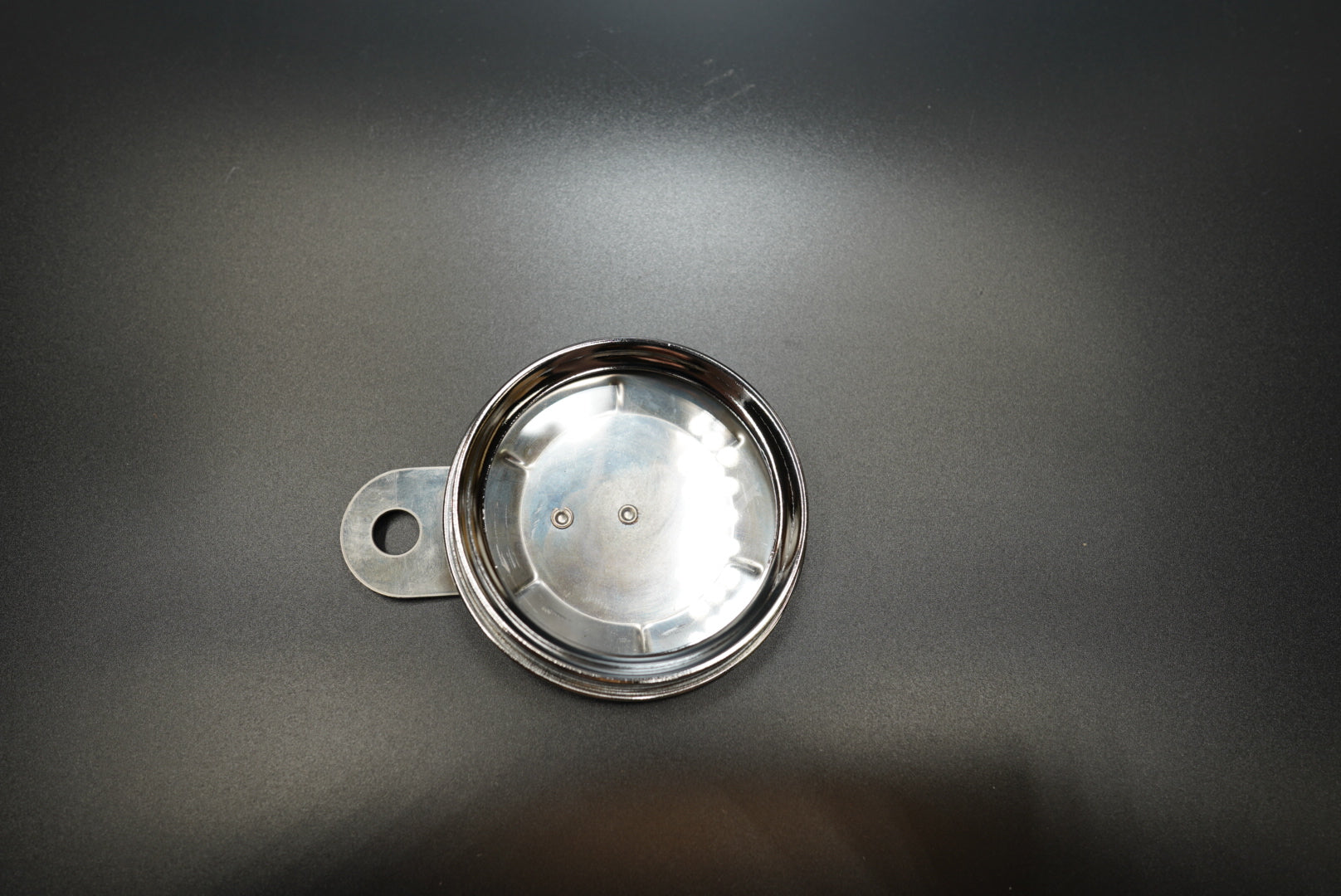 Angled view of classic round number plate highlighting smooth curved edge