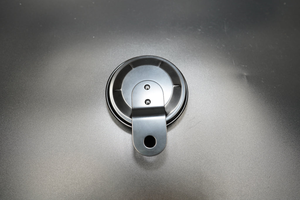 Front-facing view of metal number plate with single mounting hole