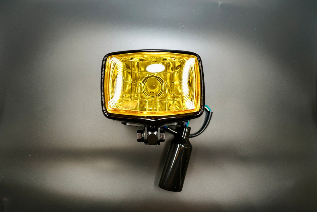Front main view of vintage-style square motorcycle headlight with yellow lens — compact 4.5-inch retro design.