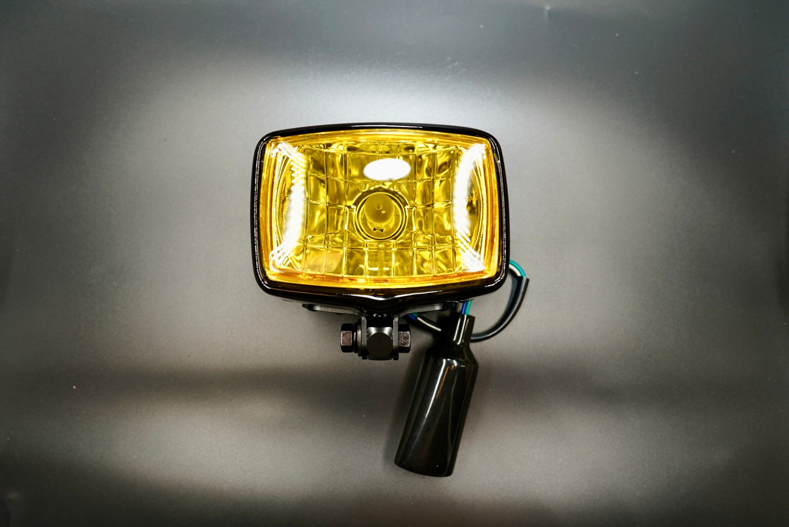 Front main view of vintage-style square motorcycle headlight with yellow lens — compact 4.5-inch retro design.