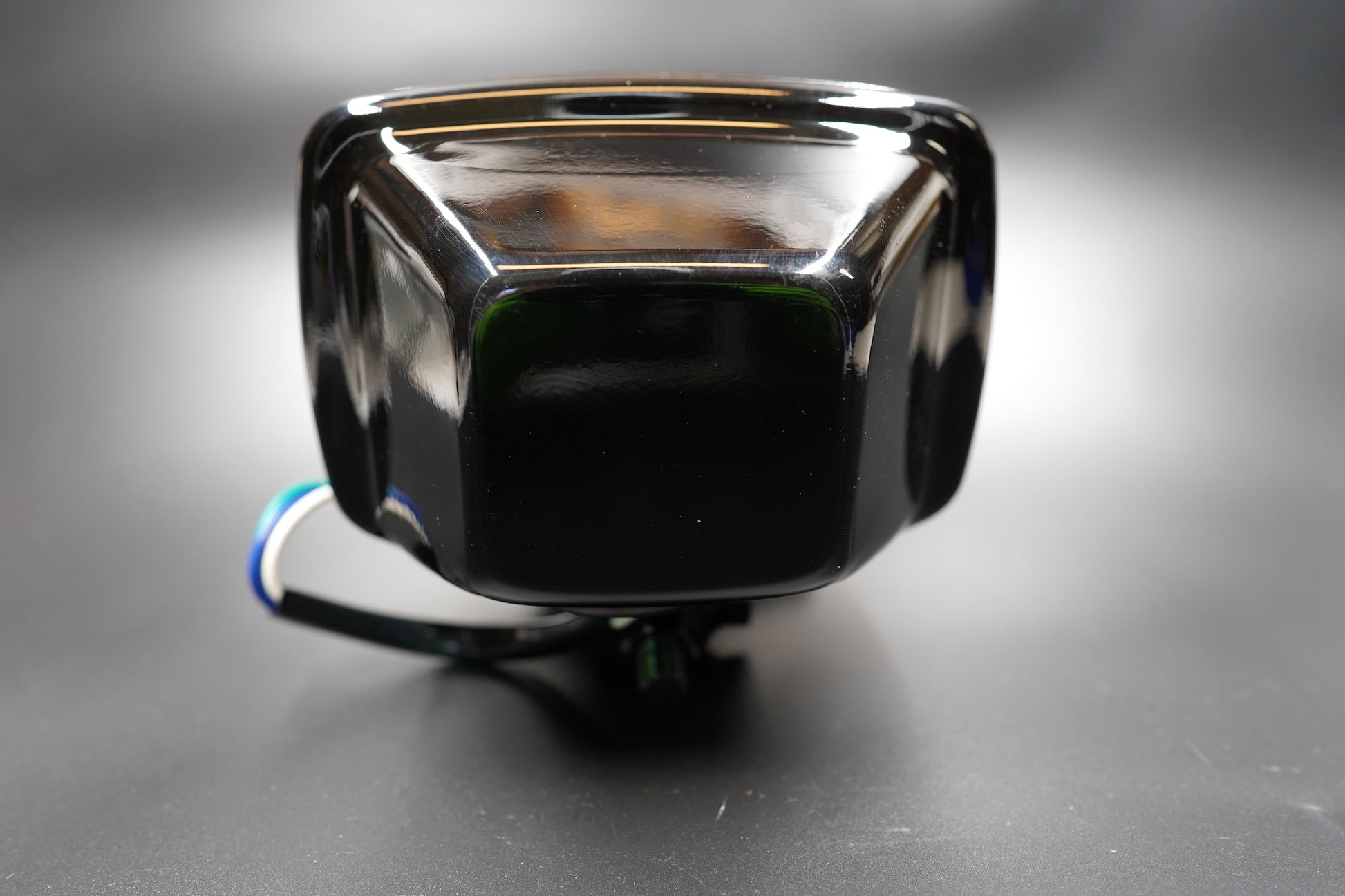 Rear view showing mounting bracket and H4 bulb connector — ready for installation.