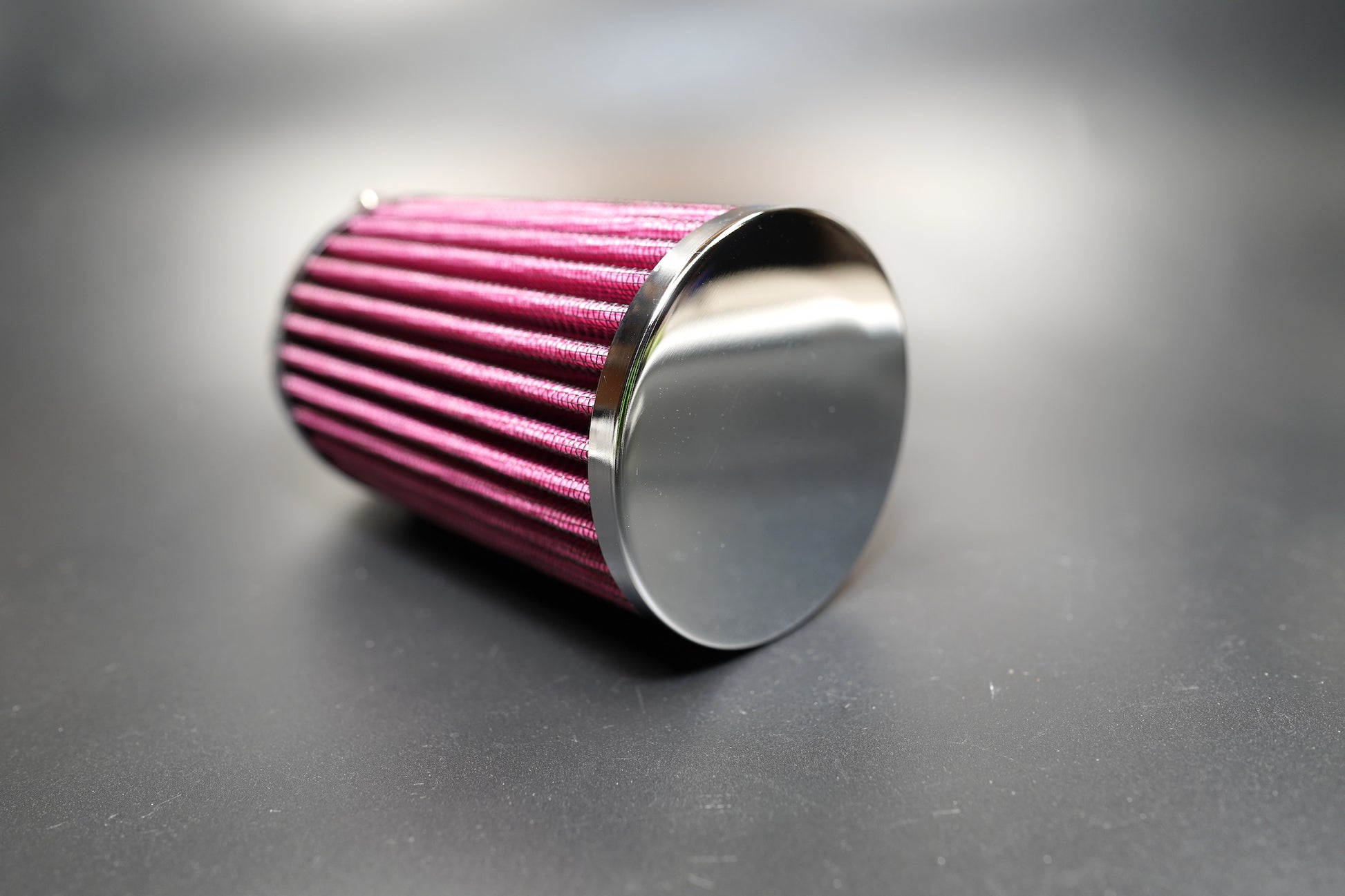 Angled shot highlighting the filter’s tapered chrome edge and cotton pleats. 
