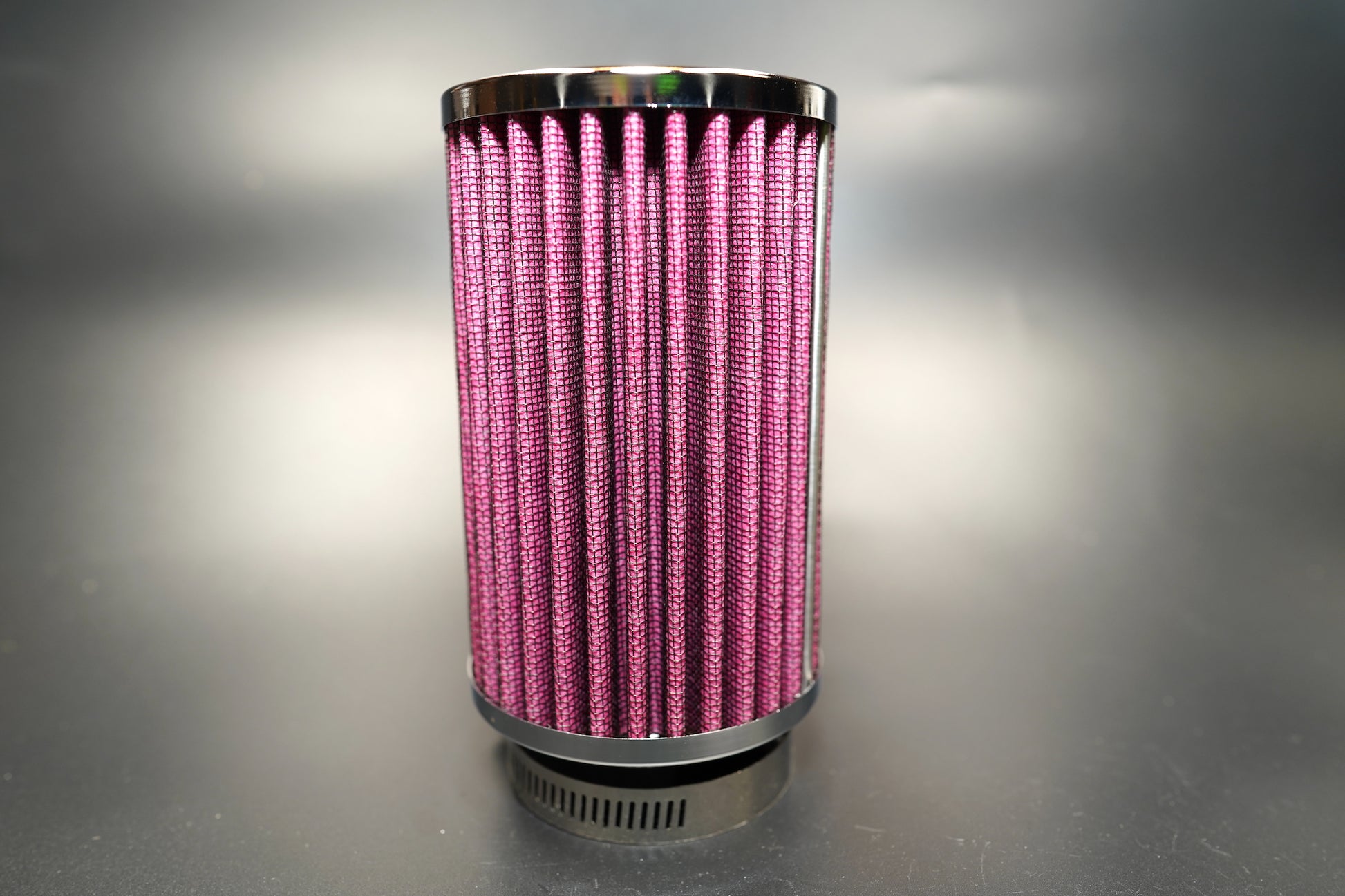 Side view showing pleated red filter media and chrome top cap. 