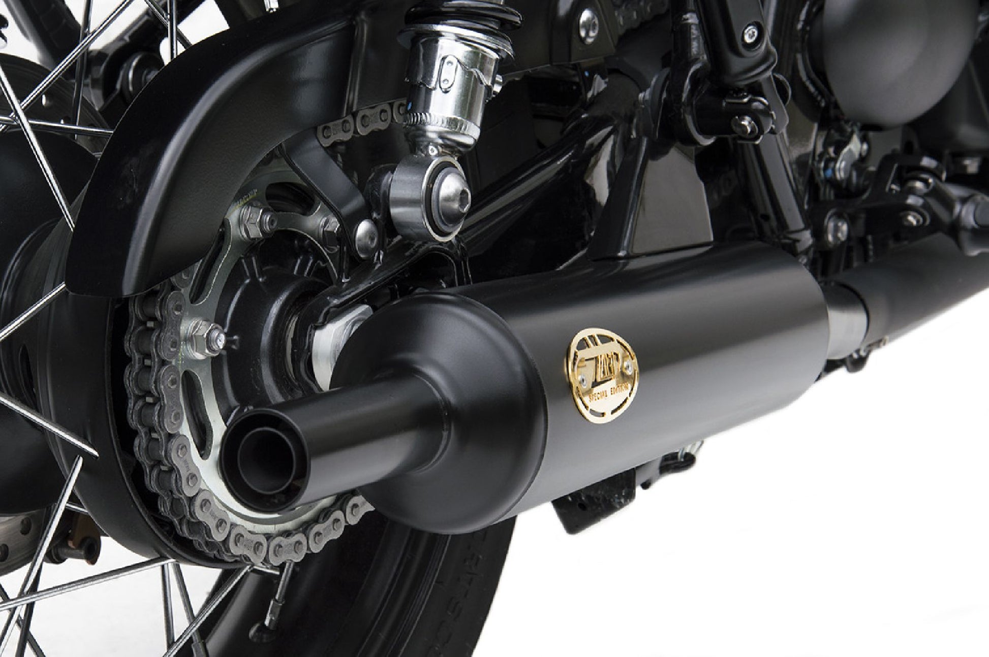 Close-up of Zard “Bottle” slip-on exhaust on Triumph Bonneville T120 — brushed stainless finish and precise fitment.
