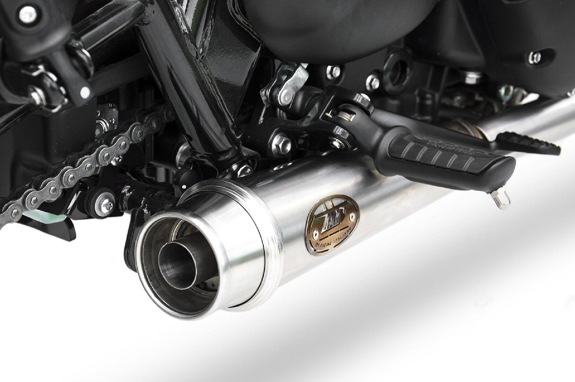 Close-up of Zard full exhaust kit with OEM catalyst on Triumph Bonneville T120 — precision welds and brushed finish.